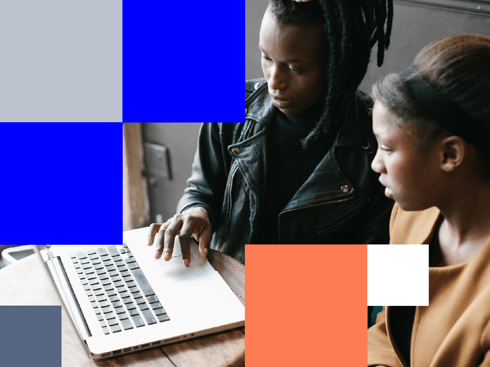 Two women working on a laptop together