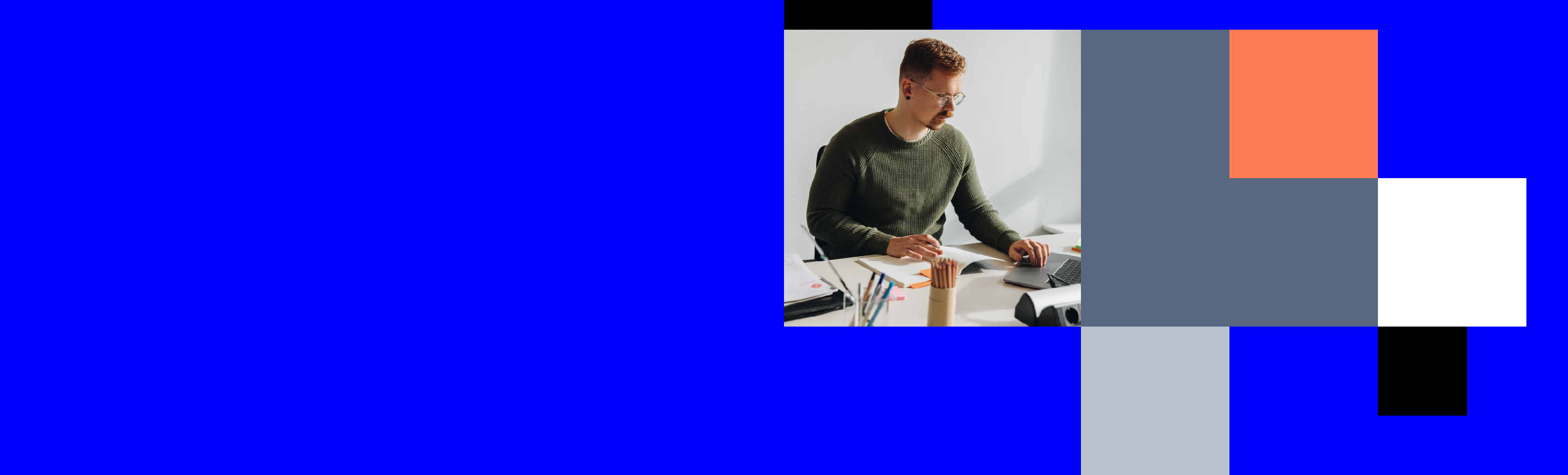A man is seated at a desk