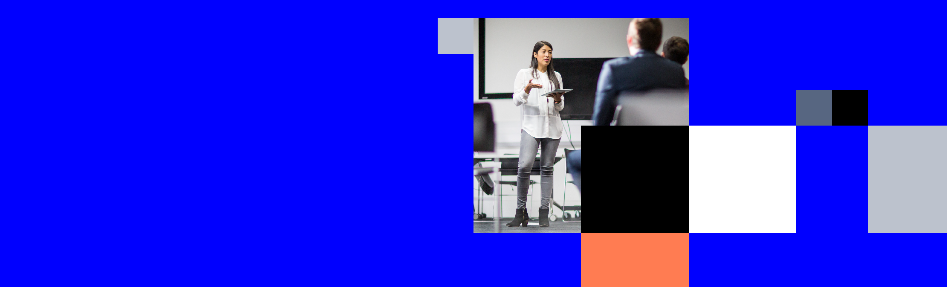 A woman is standing, giving a presentation.